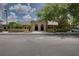 Beautiful clubhouse entrance with manicured landscaping, offering a welcoming space for community gatherings and events at 20744 Queen Alexandra Dr, Leesburg, FL 34748