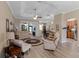 Bright and airy living room featuring hardwood floors, neutral colors, and comfortable seating area at 20744 Queen Alexandra Dr, Leesburg, FL 34748