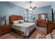 Light-filled main bedroom with wooden furniture, a ceiling fan, and wood-look floors at 20744 Queen Alexandra Dr, Leesburg, FL 34748