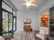 Comfortable sunroom featuring vinyl flooring, a ceiling fan, and seamless access to the kitchen at 20744 Queen Alexandra Dr, Leesburg, FL 34748