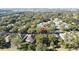 House location shown in wide aerial view of neighborhood and golf course at 2211 Stonebridge Way, Clermont, FL 34711