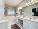 Double vanity bathroom with a large soaking tub and updated fixtures at 2211 Stonebridge Way, Clermont, FL 34711