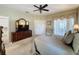 Primary bedroom with a ceiling fan, ensuite bathroom and walk-in closet at 2211 Stonebridge Way, Clermont, FL 34711