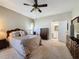 Primary bedroom with ceiling fan, large closet, and access to the bathroom at 2211 Stonebridge Way, Clermont, FL 34711