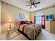 Cozy bedroom with a ceiling fan and large window at 2211 Stonebridge Way, Clermont, FL 34711