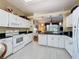 Well-equipped kitchen featuring white cabinets, granite countertops, and stainless steel appliances at 2211 Stonebridge Way, Clermont, FL 34711