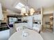 Modern kitchen with white cabinets, granite countertops, and a skylight at 2211 Stonebridge Way, Clermont, FL 34711