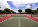 Well-maintained tennis courts with red and green surfaces at 2211 Stonebridge Way, Clermont, FL 34711