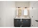 Modern bathroom featuring double vanity, tile backsplash, and brushed gold fixtures at 23503 Valderama Ln, Sorrento, FL 32776