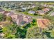 Aerial view of the property highlighting the roof, landscaping, and neighborhood at 3530 Mulberry Grove Loop, Leesburg, FL 34748