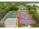 Community tennis courts near a clubhouse with parking and a view of a lake at 3530 Mulberry Grove Loop, Leesburg, FL 34748