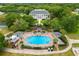 Stunning aerial view of pool, clubhouse, and lush landscaping at 3530 Mulberry Grove Loop, Leesburg, FL 34748