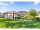 Beautifully landscaped backyard featuring lush lawn, hedges, and a screened lanai at 3530 Mulberry Grove Loop, Leesburg, FL 34748