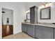 Bathroom featuring double sinks, granite counters and gray cabinetry at 3530 Mulberry Grove Loop, Leesburg, FL 34748