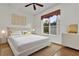 Bright bedroom featuring a stylish upholstered bed frame, modern decor, and a sunny window view at 3530 Mulberry Grove Loop, Leesburg, FL 34748