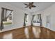 Bedroom with hardwood floors, a ceiling fan, natural light from windows, and a closet at 3530 Mulberry Grove Loop, Leesburg, FL 34748