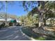 Picturesque clubhouse featuring manicured landscaping and mature trees along a winding driveway at 3530 Mulberry Grove Loop, Leesburg, FL 34748