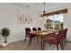 Dining area with chandelier, a dining table, and a window with natural light at 3530 Mulberry Grove Loop, Leesburg, FL 34748