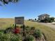 Welcome to the Plantation Golf and Country Club sign with lush flowerbeds and greenery at 3530 Mulberry Grove Loop, Leesburg, FL 34748