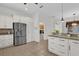 Well-equipped kitchen with stainless steel refrigerator and breakfast bar area at 3530 Mulberry Grove Loop, Leesburg, FL 34748