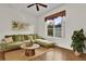 Inviting living room with a comfortable green sofa, wooden table, and natural light at 3530 Mulberry Grove Loop, Leesburg, FL 34748