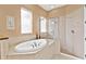 Bathroom with a soaking tub and walk-in shower at 38728 Oak Place Ct, Lady Lake, FL 32159