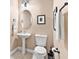 Small bathroom with pedestal sink and toilet at 38728 Oak Place Ct, Lady Lake, FL 32159