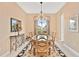 Elegant dining room with a chandelier and seating for six at 38728 Oak Place Ct, Lady Lake, FL 32159