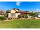 One-story home with a circular turret, brown roof, and landscaped yard at 38728 Oak Place Ct, Lady Lake, FL 32159