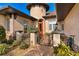 Inviting front entrance with red door, stone accents, and wrought iron gate at 38728 Oak Place Ct, Lady Lake, FL 32159