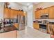 Kitchen with stainless steel appliances and light wood cabinets at 38728 Oak Place Ct, Lady Lake, FL 32159