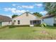 The property features a lush green lawn and tidy landscaping bordering the screened-in porch area at 4130 Capland Ave, Clermont, FL 34711