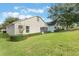 The property boasts a pristine lawn area and meticulously trimmed shrubs surrounding the exterior at 4130 Capland Ave, Clermont, FL 34711