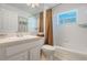 Well-lit bathroom features a tub, shower, and vanity, providing essential amenities in a clean design at 4130 Capland Ave, Clermont, FL 34711