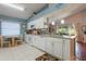 Updated kitchen featuring a breakfast nook, stainless appliances, and granite countertops is ideal for modern living at 4130 Capland Ave, Clermont, FL 34711