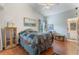 Cozy bedroom with vaulted ceilings, hardwood floors, and ensuite bath provides a comfortable retreat at 4130 Capland Ave, Clermont, FL 34711