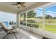 Screened in patio offers a relaxing outdoor space with views of the landscaped yard and community at 4130 Capland Ave, Clermont, FL 34711