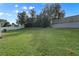 Large grassy backyard with a wooden fence at 630 Plumwood Dr, Altamonte Springs, FL 32714