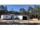 Newly constructed one-story home with attached garage and dark gray roof at 8374 Sw 125Th Ter, Dunnellon, FL 34432