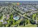 Aerial view of a community with houses, pool, and golf course at 1315 Greenville Way, The Villages, FL 32162