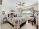 Charming bedroom with a floral bedspread and sitting area at 1315 Greenville Way, The Villages, FL 32162