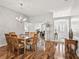 Bright dining room featuring hardwood floors and an elegant chandelier at 1315 Greenville Way, The Villages, FL 32162