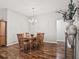 Formal dining area with hardwood floors and a chandelier, open to the kitchen at 1315 Greenville Way, The Villages, FL 32162