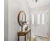 Light and airy entryway, featuring a console table and decorative mirror at 1315 Greenville Way, The Villages, FL 32162