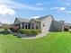 Single-story home with screened porch, landscaped yard, and white rock garden at 1315 Greenville Way, The Villages, FL 32162