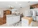 Modern kitchen with large island, stainless steel appliances and hardwood floors at 1315 Greenville Way, The Villages, FL 32162