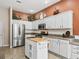 Clean kitchen with white cabinets, stainless steel appliances, and granite countertops at 1315 Greenville Way, The Villages, FL 32162