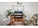 Cozy living room featuring hardwood floors, comfy seating and a ceiling fan at 1315 Greenville Way, The Villages, FL 32162