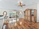 Open living area with hardwood floors and access to a screened-in porch at 1315 Greenville Way, The Villages, FL 32162