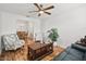 Relaxing living room with hardwood floors, comfortable seating and a view to dining area at 1315 Greenville Way, The Villages, FL 32162